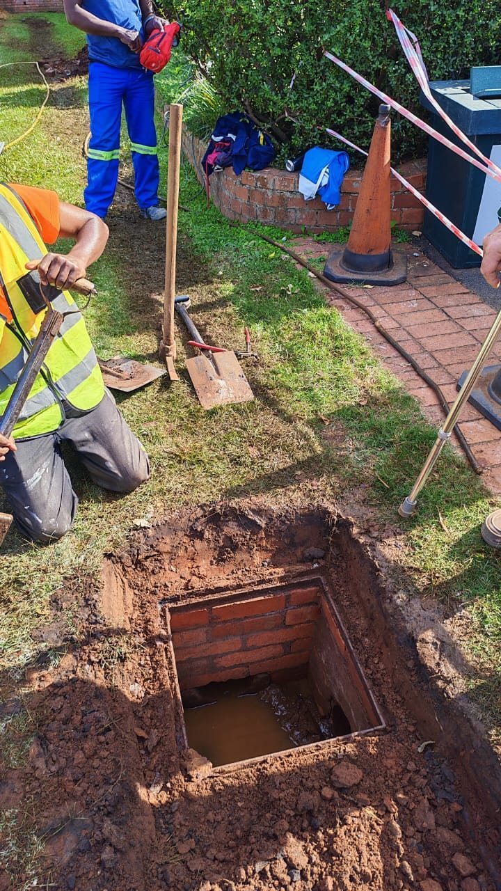 Dudley's Plumbers team working on a blocked drain in Durban North