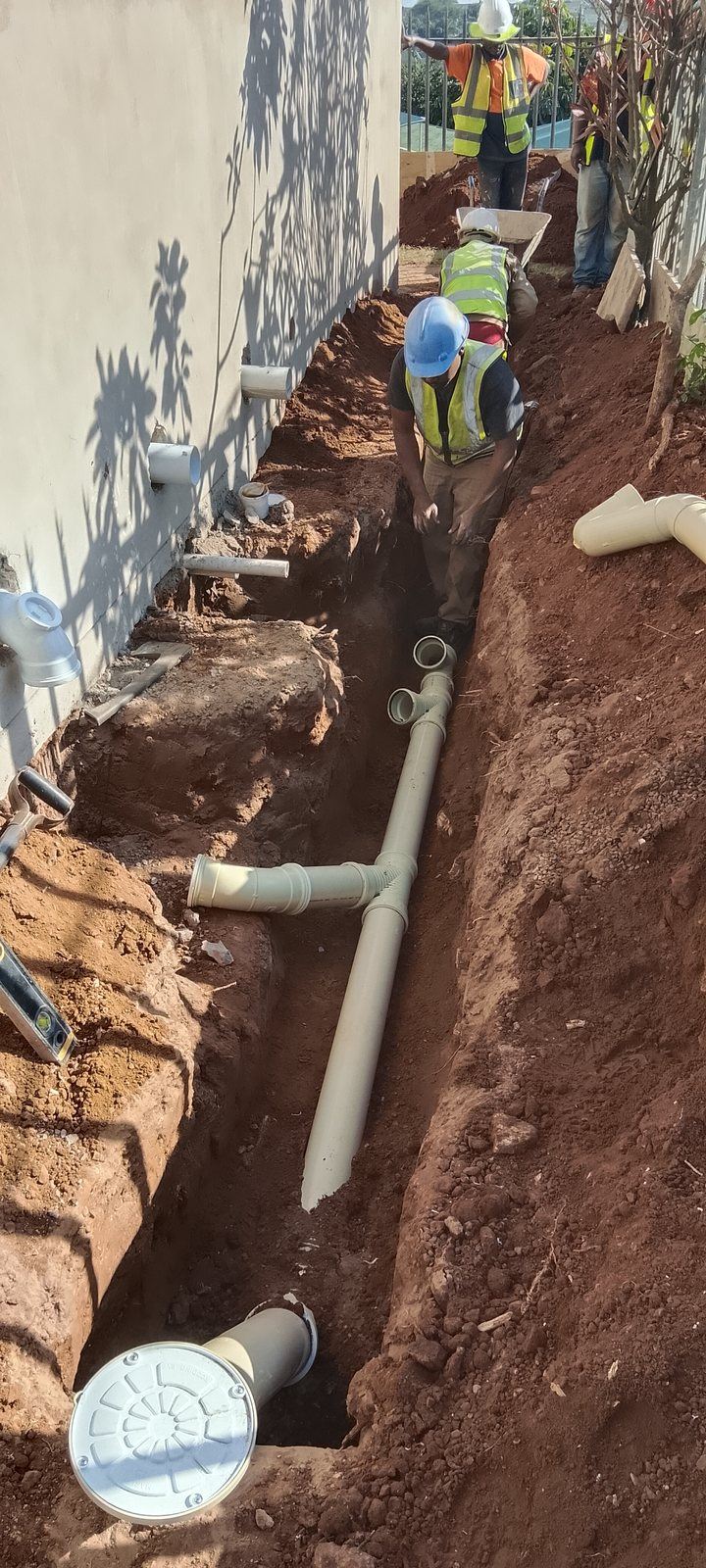 Dudley's Plumbers clearing a blocked drain inspection chamber in Durban North